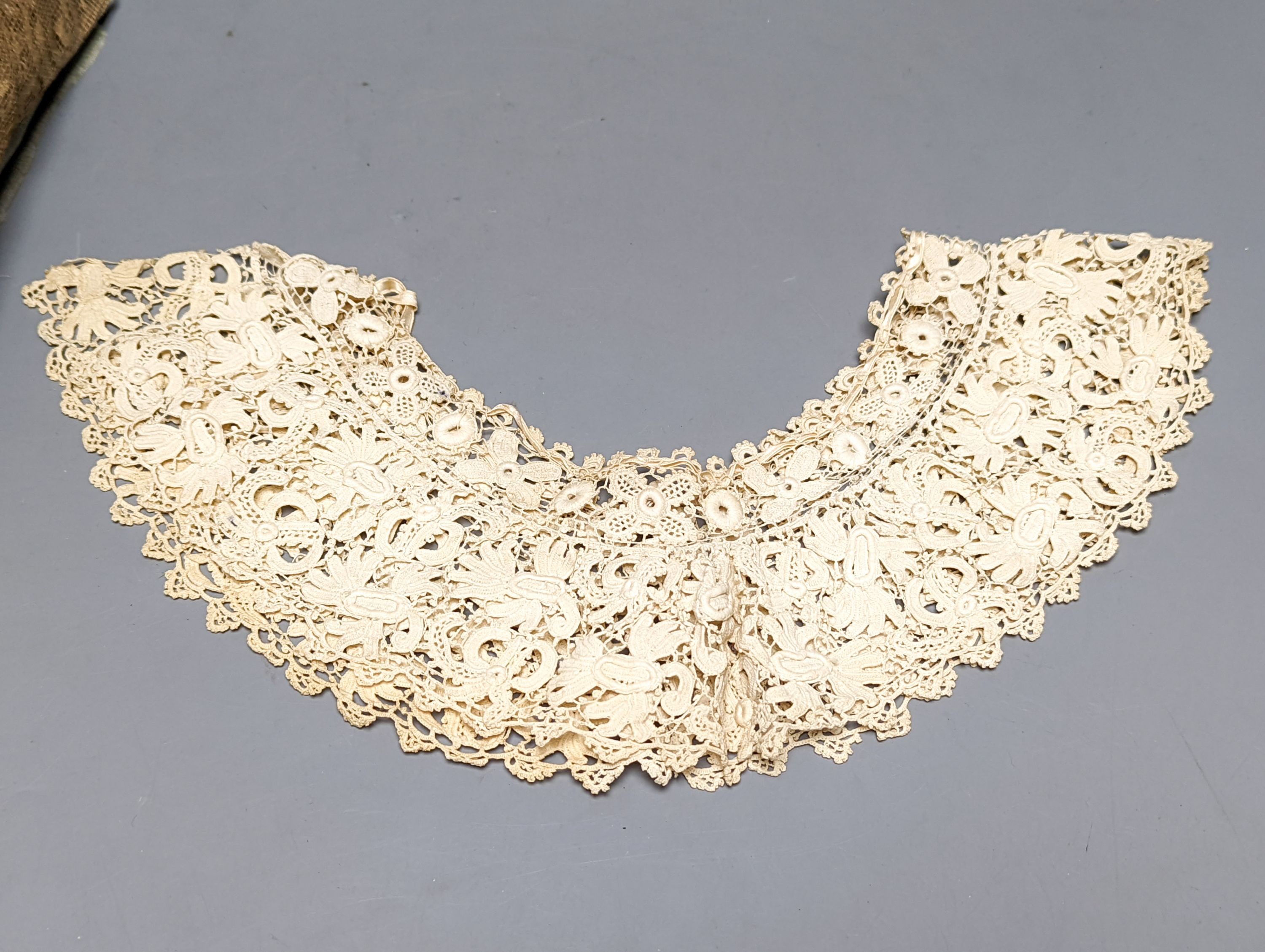 A filet lace box containing a silk Maltese hand bobbin lace veil and stole and an Irish crochet collar and machine net veil
